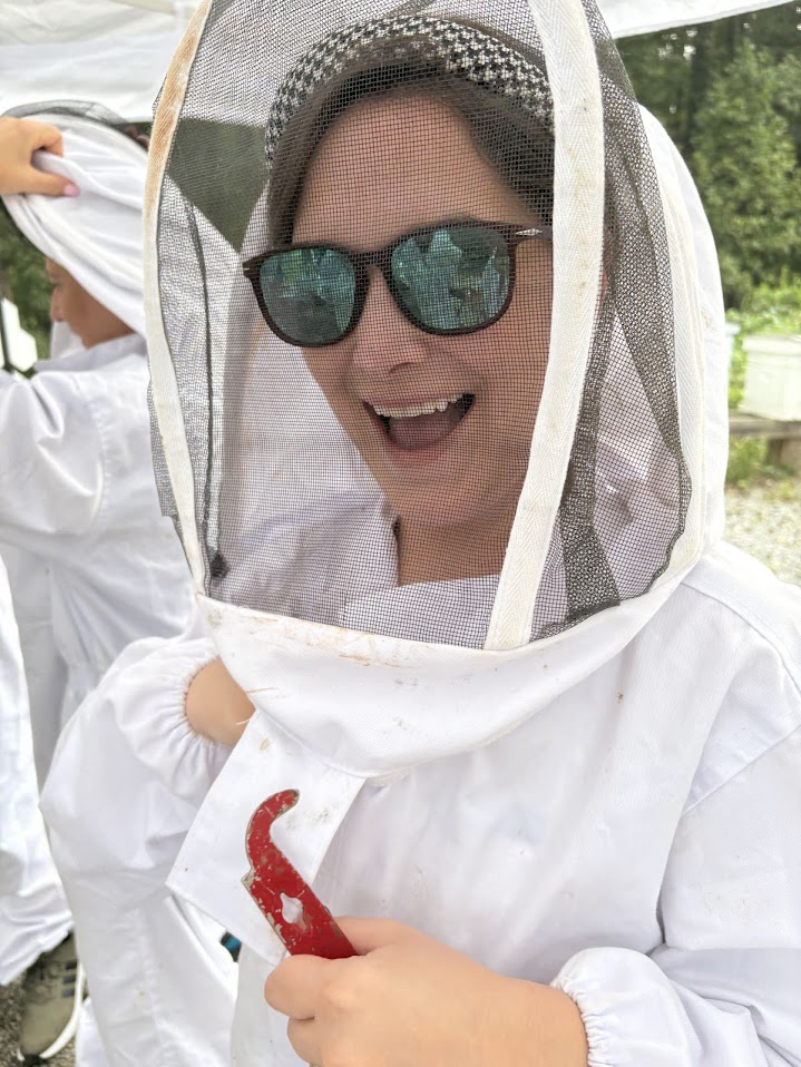 Ola Learning How to Check Bee Hives for Honey